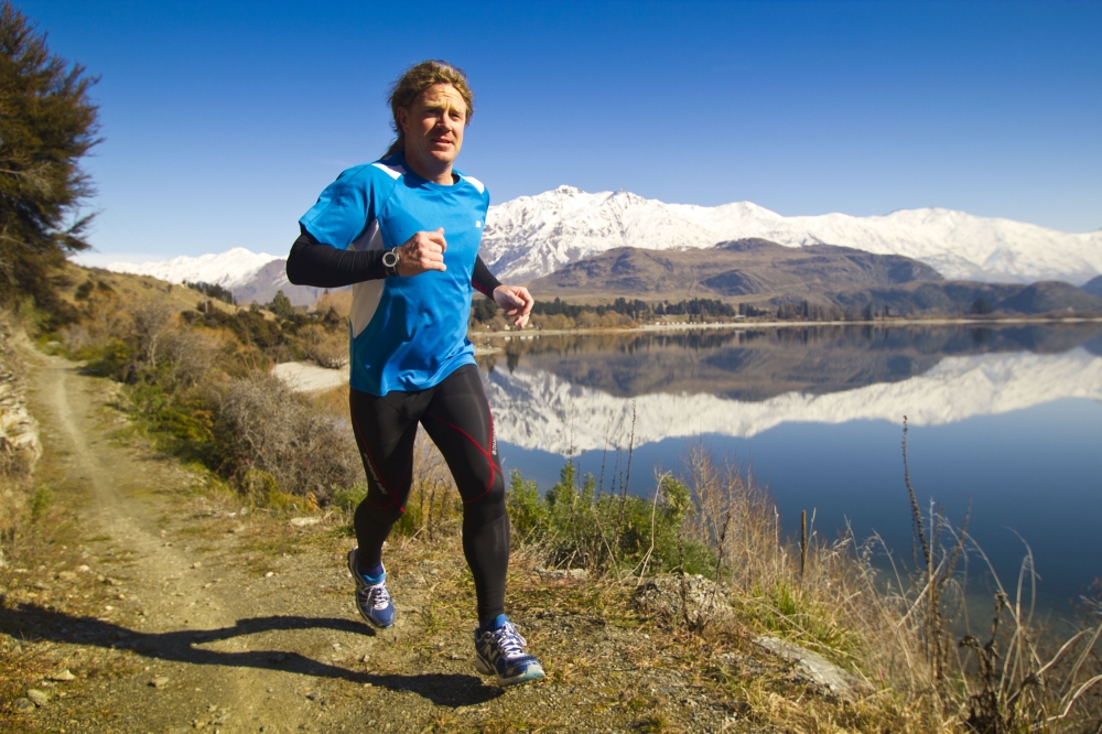 Jup Running By Lake Wanaka With Treble Cone Background